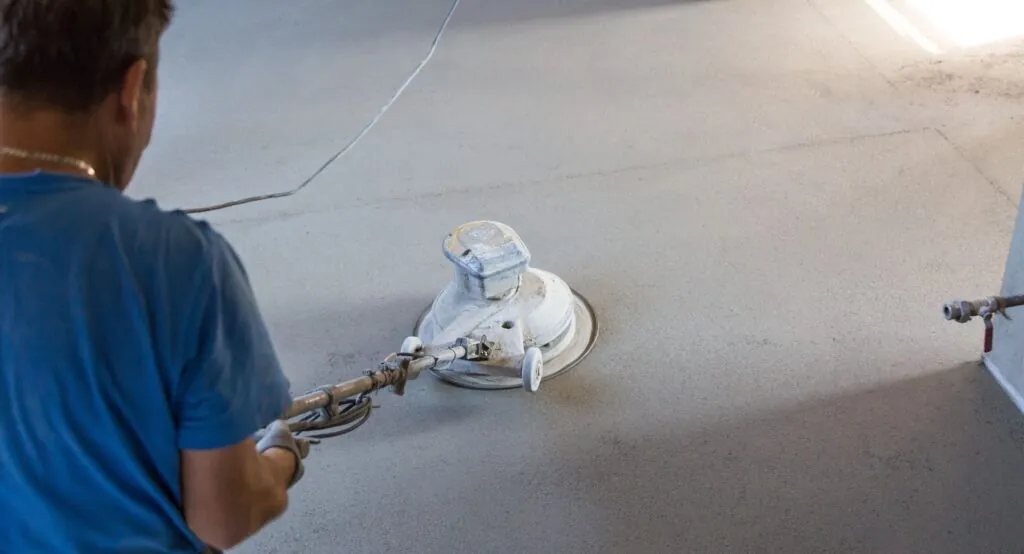 worker polishing concrete floor